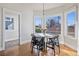 Breakfast nook area with a round table next to large windows at 1215 S Ogden St, Denver, CO 80210