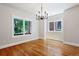 Bright dining room with hardwood floors, modern chandelier, and large windows at 1215 S Ogden St, Denver, CO 80210