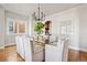 Dining room with seating for eight, hardwood floors, modern chandelier, and built-in cabinets at 1215 S Ogden St, Denver, CO 80210