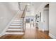 Bright and airy foyer with hardwood floors, staircase, and modern console table at 1215 S Ogden St, Denver, CO 80210