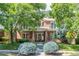 Beautiful brick two-story home with manicured lawn and mature trees at 1215 S Ogden St, Denver, CO 80210