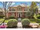 Beautiful brick two-story home featuring manicured front yard and charming architectural details at 1215 S Ogden St, Denver, CO 80210