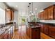 Gourmet kitchen featuring granite countertops, stainless steel appliances, and center island at 1215 S Ogden St, Denver, CO 80210