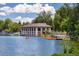 Scenic view of a lakeside boathouse with paddle boats and clear blue water at 1215 S Ogden St, Denver, CO 80210