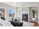 Inviting living room with a fireplace, modern decor, comfortable seating, and an abundance of natural light at 1215 S Ogden St, Denver, CO 80210