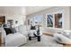 Spacious living room with a large sectional sofa, stylish decor, and large windows offering natural light at 1215 S Ogden St, Denver, CO 80210