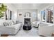 Relaxing living room featuring a fireplace, comfortable seating, modern decor, and ample natural light at 1215 S Ogden St, Denver, CO 80210