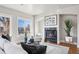 Cozy living room with a fireplace, large windows, and hardwood floors at 1215 S Ogden St, Denver, CO 80210