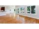 Open-concept living room featuring gleaming hardwood floors and ample natural light at 1215 S Ogden St, Denver, CO 80210