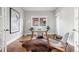 Bright home office with a large window, modern furnishings, hardwood floors, and artwork at 1215 S Ogden St, Denver, CO 80210