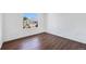 An empty bedroom with hardwood floors and a large window, ready for your personal touch at 9735 E 112Th Pl, Commerce City, CO 80640