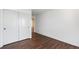 A bedroom with wood flooring and sliding door closet with additional room access at 9735 E 112Th Pl, Commerce City, CO 80640