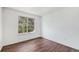 The bedroom has wood flooring and a window overlooking nature at 9735 E 112Th Pl, Commerce City, CO 80640