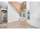 Inviting foyer featuring high ceilings, staircase, arched openings, and easy access to living spaces at 9735 E 112Th Pl, Commerce City, CO 80640