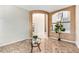 Inviting entryway featuring tile flooring, arched openings, and a view of the staircase and upper level at 9735 E 112Th Pl, Commerce City, CO 80640