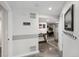 Bright hallway featuring modern decor, sleek flooring, and convenient access to various rooms at 9735 E 112Th Pl, Commerce City, CO 80640