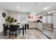 Cozy basement kitchen with stainless steel appliances, modern cabinets, and a dining area at 9735 E 112Th Pl, Commerce City, CO 80640