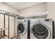 The laundry room has a front-loading washer and dryer and shelving at 9735 E 112Th Pl, Commerce City, CO 80640