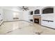 Spacious living room with marble floors, a ceiling fan, built-in shelves and a cozy fireplace at 9735 E 112Th Pl, Commerce City, CO 80640