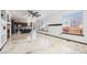 Open-concept living area with marble floors, fireplace, and seamless flow into the kitchen and dining spaces at 9735 E 112Th Pl, Commerce City, CO 80640