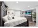Spacious main bedroom with a luxurious bed, modern decor, and a large window for natural light at 9735 E 112Th Pl, Commerce City, CO 80640