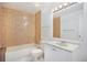 Bathroom featuring tile details in shower and vanity with sink and storage at 1303 Havana St, Aurora, CO 80010