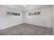 Bright bedroom with neutral carpet, white walls, and dual windows at 1303 Havana St, Aurora, CO 80010
