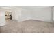 Spacious living room featuring neutral carpeting, white walls, and plenty of natural light at 1303 Havana St, Aurora, CO 80010