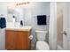 Well-lit bathroom with a single sink vanity, mirror, and shower with a curtain at 767 Roslyn St # 20, Denver, CO 80230