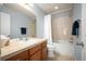 Bathroom with neutral colored vanity, large mirror, and shower/tub combination at 767 Roslyn St # 20, Denver, CO 80230