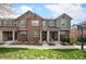 Inviting townhome exterior boasts brick and siding, a charming entryway, and well-maintained landscaping at 767 Roslyn St # 20, Denver, CO 80230