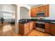 Stylish kitchen with stainless steel appliances, granite countertops, and hardwood floors, perfect for cooking at 767 Roslyn St # 20, Denver, CO 80230