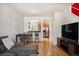 Open-concept living room flowing into the kitchen, featuring hardwood floors and modern decor at 767 Roslyn St # 20, Denver, CO 80230