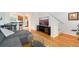 Sunlit living room with hardwood floors, comfy seating, and easy access to kitchen at 767 Roslyn St # 20, Denver, CO 80230