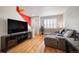 Contemporary living room with hardwood floors, modern decor, and large windows for natural light at 767 Roslyn St # 20, Denver, CO 80230