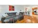Open-concept living room boasts hardwood floors and a comfortable gray sofa at 767 Roslyn St # 20, Denver, CO 80230