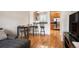 Spacious living area with hardwood floors connecting to the kitchen and dining area, perfect for entertaining at 767 Roslyn St # 20, Denver, CO 80230