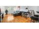 Cozy living room features hardwood floors, gray couch and a table with bar stools at 767 Roslyn St # 20, Denver, CO 80230