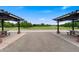 Park view featuring picnic benches under trellis structures, near green space and trees at 767 Roslyn St # 20, Denver, CO 80230