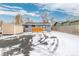 Rear of a home with snowy gravel landscaping, a utility shed, and an enclosed yard at 47 S Hazel Ct, Denver, CO 80219