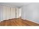 Bedroom features wood-look flooring, a window, and a closet with a curtain for storage solutions at 47 S Hazel Ct, Denver, CO 80219