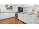 Updated kitchen featuring granite countertops, white cabinets, and stainless steel appliances at 47 S Hazel Ct, Denver, CO 80219