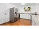 Well-equipped kitchen featuring stainless steel refrigerator, granite countertops, and open shelving at 47 S Hazel Ct, Denver, CO 80219