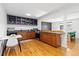 Modern kitchen with stainless steel appliances, dark countertops, light wood cabinets, and breakfast nook at 47 S Hazel Ct, Denver, CO 80219