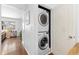 Convenient laundry area with stacked washer and dryer units tucked in a closet at 47 S Hazel Ct, Denver, CO 80219