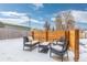 Modern outdoor seating area with an outdoor coffee table and yellow accent pillow at 47 S Hazel Ct, Denver, CO 80219