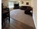 Spacious living room featuring plush carpeting, a ceiling fan, and a comfortable, large sectional sofa at 47314 Iris Ave, Bennett, CO 80102