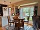 Cozy dining area with a wooden table and chairs, a window view, and modern pendant lights at 1778 S Lee St, Lakewood, CO 80232
