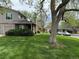 Exterior of home with lush green lawn, mature trees, and well kept yard at 1778 S Lee St, Lakewood, CO 80232