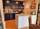 Well-lit kitchen with dark cabinets, granite countertops, stainless steel appliances and wooden floor at 1778 S Lee St, Lakewood, CO 80232